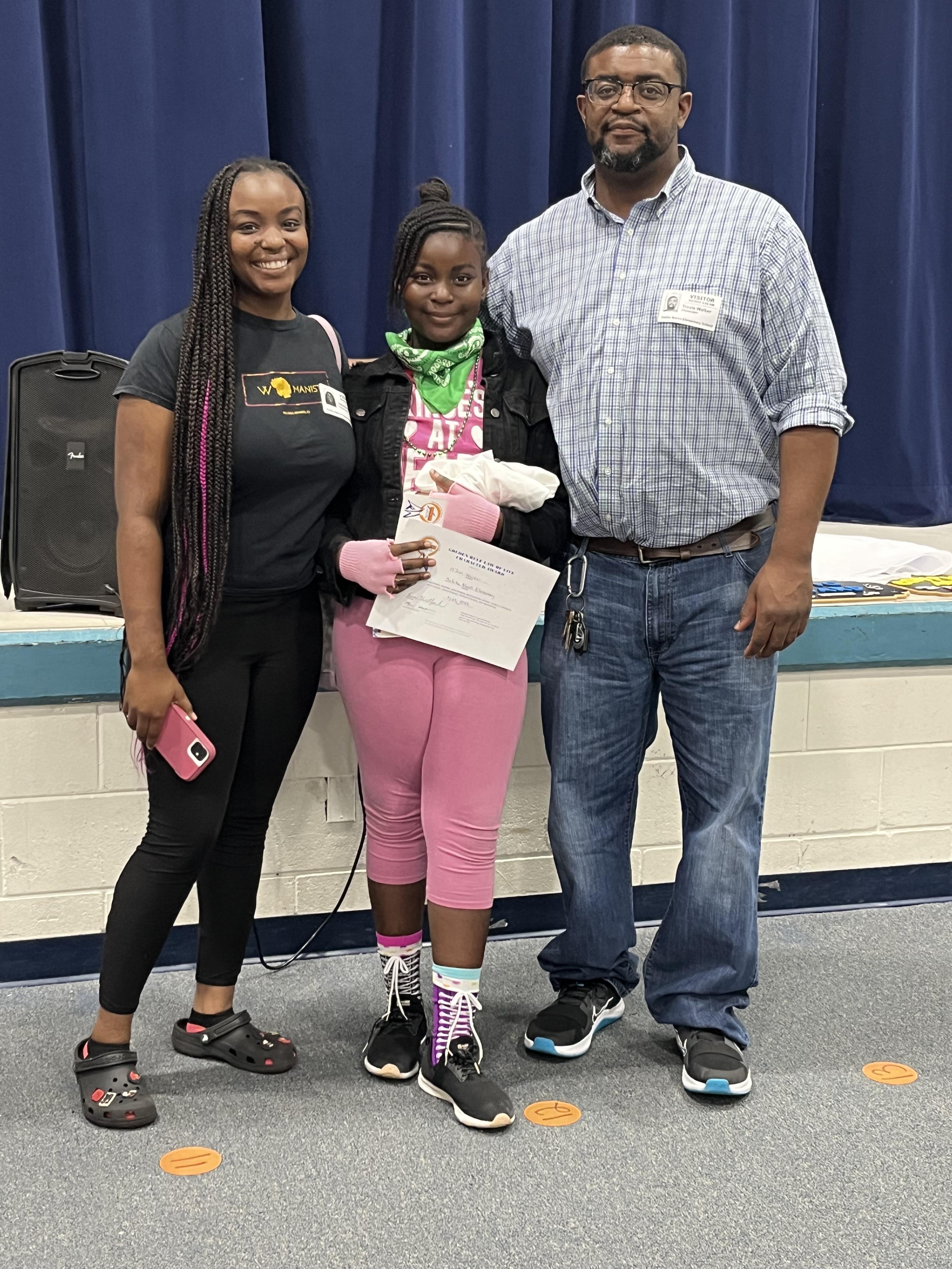 girl stands with parents